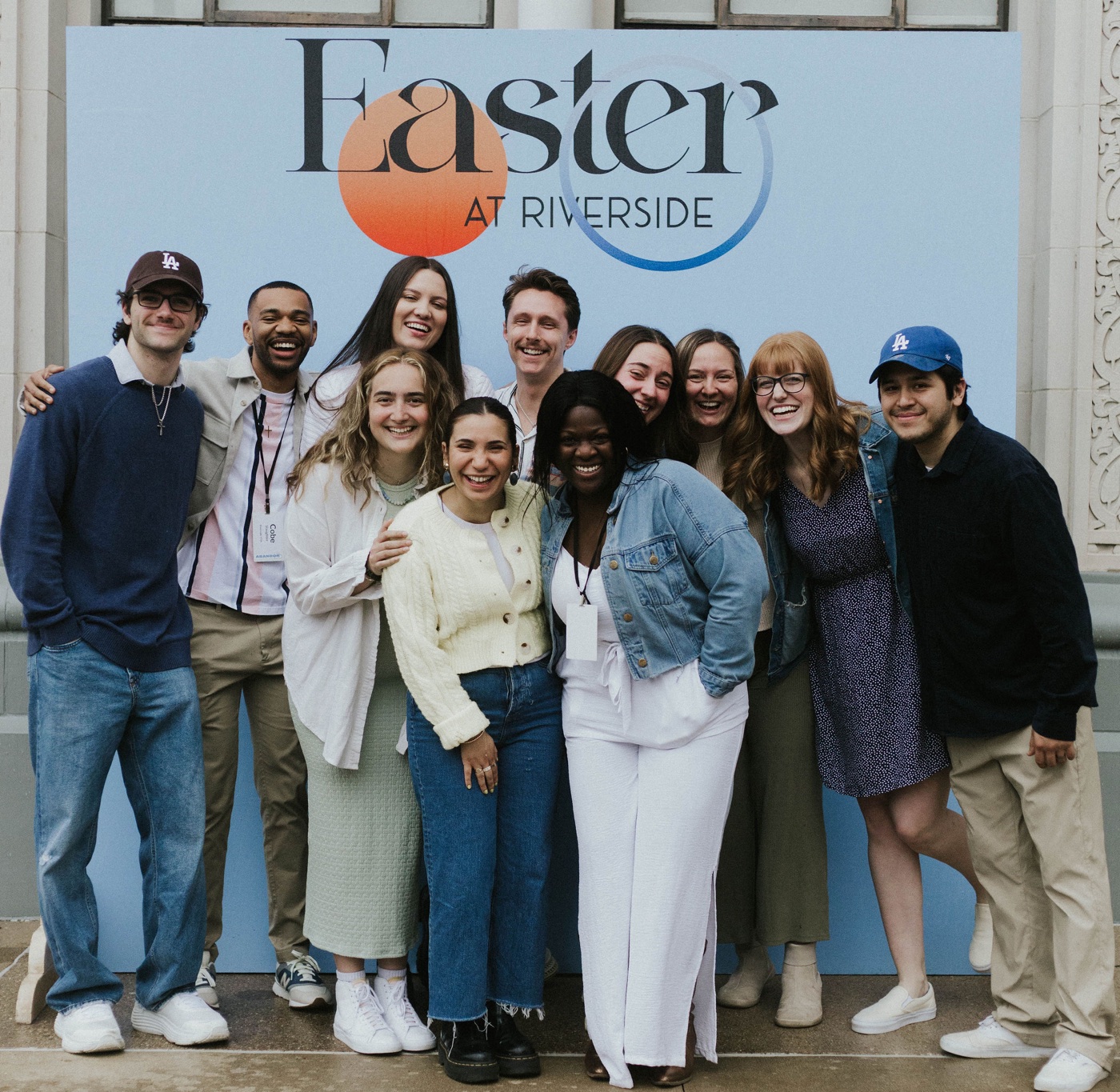 Jack and the Riverside creative team in front of the printed Easter at Riverside photo wall.